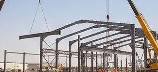 Cranes erecting a steel frame on site